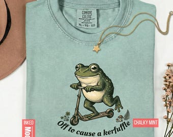 Camiseta divertida con meme de rana para armar un alboroto, estilo cottagecore, con estampado de patinete de rana.