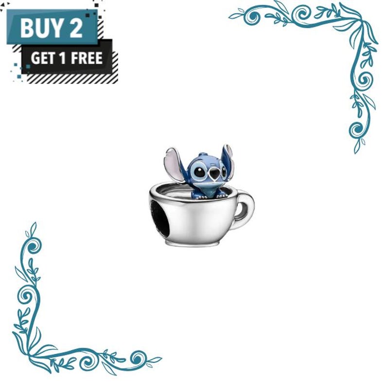 May include: A silver-toned metal charm featuring a blue character with large ears sitting inside a small cup. The image includes text that reads BUY 2 GET 1 FREE in a black and blue box. The charm has a polished finish and a handle on the side.