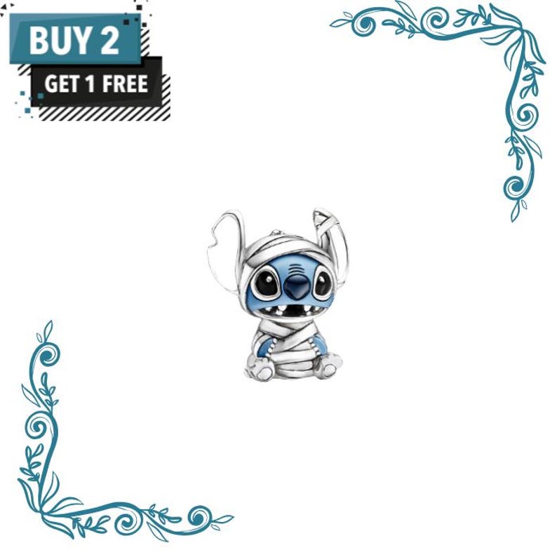 May include: A silver charm shaped like a blue alien character wrapped in white bandages, featuring large black eyes and a wide grin. The image includes text that reads BUY 2 GET 1 FREE in a dark blue and black box in the upper left corner.