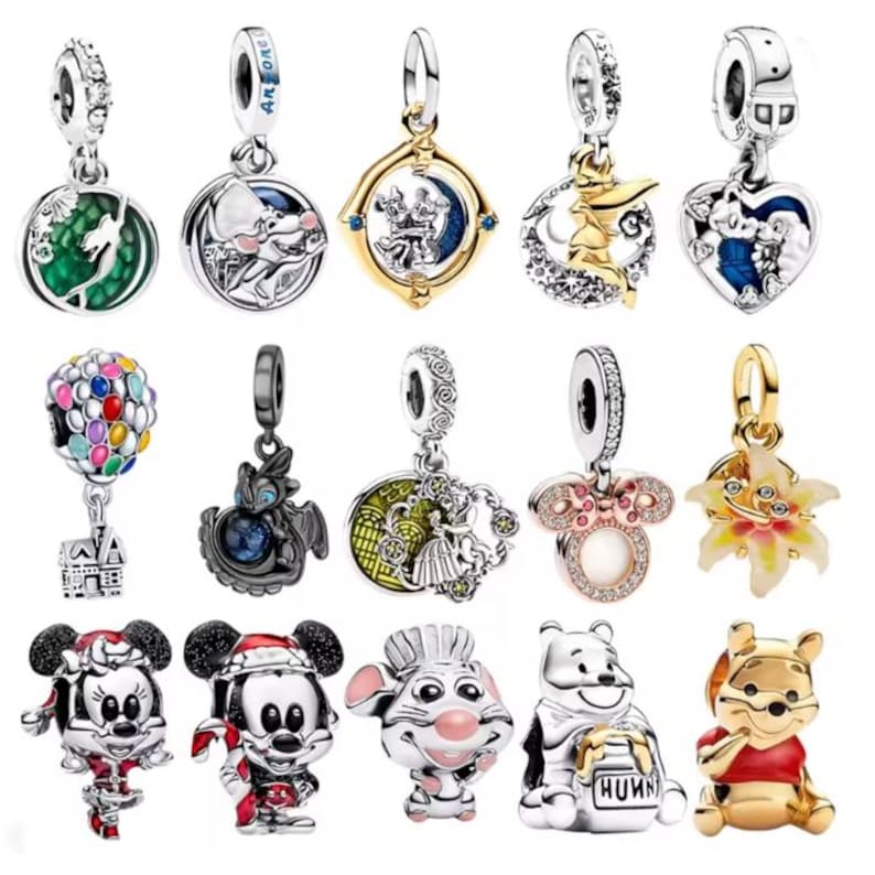 May include: A collection of silver charms with various designs, including Disney characters like Mickey and Minnie Mouse, Winnie the Pooh, and other whimsical elements. Some charms feature colorful accents and gemstones, perfect for bracelets or necklaces.
