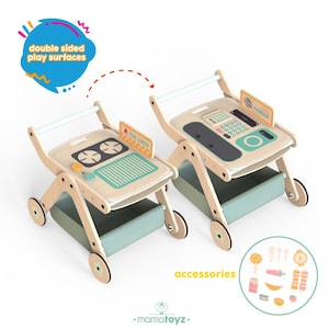 May include: Two wooden toy play carts with double-sided play surfaces. One side features a stove and grill, the other a cash register. Each cart has a storage bin and accessories. The carts are light wood with mint green and orange accents.