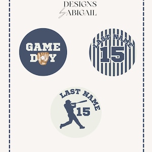 May include: Three circular baseball-themed designs with the text DESIGNS by ABIGAIL. One navy circle says GAME DAY with a glove and ball. Another has navy stripes, the text LAST NAME, and the number 15. The third is cream with a batter and 15.