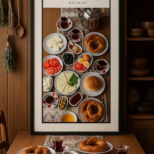 May include: A framed "Kitchen & Dining MOCKUP" image showcases a breakfast spread. The table displays plates of bagels, sliced tomatoes, cheese, olives, honey, and tea. A wooden background and shelves filled with bowls complete the scene.