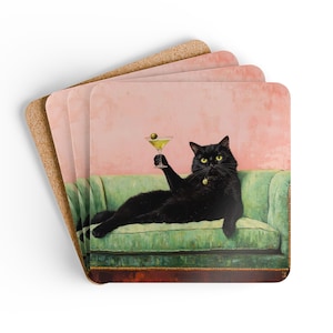 May include: Set of four square coasters. Each coaster features a black cat lounging on a green sofa, holding a martini with an olive. The background is a pink wall. The coasters have a cork backing.