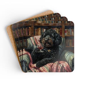 May include: Set of four square coasters with a cork backing. Each coaster features a watercolor illustration of a black dog relaxing in a chair with a glass of wine, in front of a bookshelf.