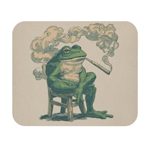 May include: A green frog illustration seated on a small wooden chair, smoking a cigarette. The frog is depicted with a relaxed posture, and smoke curls around its head. The background is a light tan color.