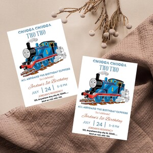 May include: Two birthday invitations featuring a blue cartoon train with the text "CHUGGA CHUGGA TWO TWO". The invitations read "All Aboard The Birthday Express To Celebrate! Jordan's 1st Birthday" with date and time details.