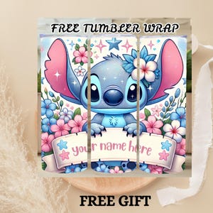 May include: A tumbler wrap featuring a cartoon character with blue fur, large pink ears, and a blue nose. The character is surrounded by pink and blue flowers and holds a banner that reads "your name here". The words "FREE TUMBLER WRAP" and "FREE GIFT" are also visible.