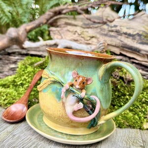 Hand-thrown ceramic mug with a little mouse on a blade of grass. A unique, lovingly handcrafted piece. This mug is a must-have for every nature lover.