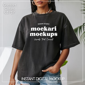 May include: A black oversized t-shirt with the text "mockari mockups" and "Design Studio" above it and "Visuals That Convert" below it. The text is in white and the shirt is worn by a person with a gold chain necklace. The text "INSTANT DIGITAL MOCKUP" is at the bottom of the image.