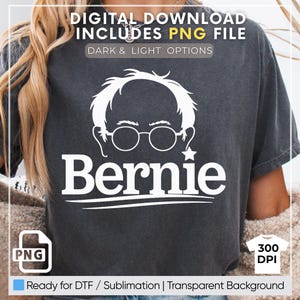May include: A dark gray t-shirt with a white graphic of Bernie Sanders' face and the word "Bernie" in white text. The graphic is on a dark gray background. The t-shirt is ready for DTF or sublimation printing and has a transparent background.