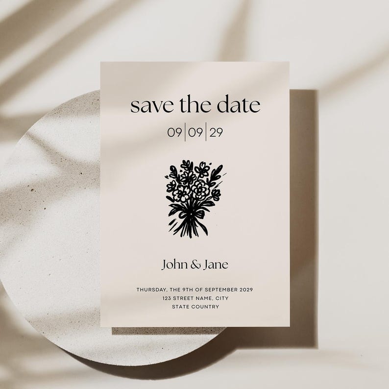 May include: Save the date card featuring a black and white illustration of a bunch of flowers. The text reads "save the date" with the date "09/09/29" underneath. The names "John & Jane" are printed below the date, followed by the date and location of the event: "THURSDAY, THE 9TH OF SEPTEMBER 2029, 123 STREET NAME, CITY, STATE COUNTRY".