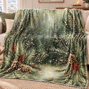May include: A soft throw blanket featuring a festive forest scene with deep green pine branches, clusters of bright red berries, and textured brown pinecones. The design includes golden speckles that resemble shimmering light across the fabric.