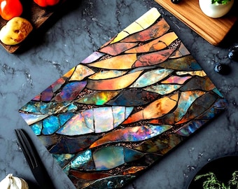 May include: A rectangular cutting board featuring a mosaic pattern of iridescent, multi-colored shards in shades of blue, orange, yellow, and purple. The surface displays a reflective, shimmering finish with dark grout lines separating each individual piece.