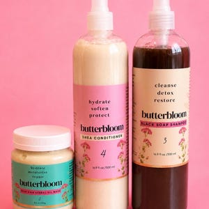May include: A Wash Day Bundle featuring three hair care products: a small jar of Butterbloom Deep Hair Herbal Oil Mask (8 oz), a bottle of Butterbloom Shea Conditioner (16.9 fl oz), and a bottle of Butterbloom Black Soap Shampoo (16.9 fl oz).