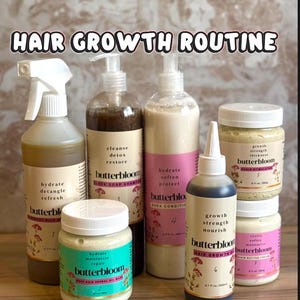 May include: A seven-piece Butterbloom hair care set including a spray bottle, two pump bottles, two jars with white lids, and two squeeze bottles. Labels feature text such as HAIR GROWTH ROUTINE, 7 STEP, and product names like Black Soap Shampoo.