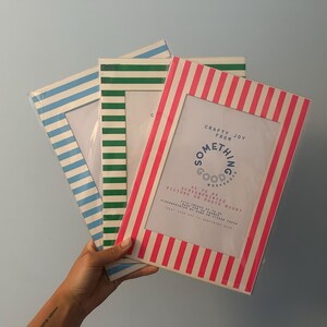 May include: Three picture frames with striped borders in blue, green, and pink. The pink frame has the text "Crafty Joy From Something Good Workshop" and is designed to be a picture or photo mount.