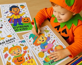 May include: A child in a pumpkin costume colors Halloween-themed coloring pages with crayons. The pages feature illustrations of a vampire, ghost, witch, and pumpkin character with the phrases "I AM BRAVE SWEET" and "I AM STRONG AND KIND".