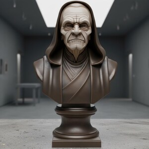 May include: A bronze-colored bust sculpture of an elderly person with a stern expression. The sculpture features a hooded cloak and is mounted on a pedestal. The bust is set against a blurred background.