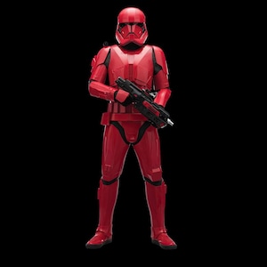 May include: A red armored figure, holding a black weapon, stands against a black background. The figure is wearing a helmet and uniform with black detailing. The image is a full-body shot.