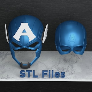 Peut inclure: Deux casques bleus Captain America avec un emblème "A" blanc. L'un est un masque complet, l'autre un demi-masque. Le texte "STL Files" est en bas.
