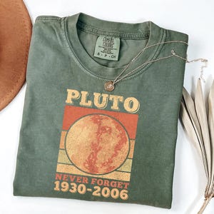 May include: A set of three ceramic mugs with a speckled, matte finish. The mugs are in shades of cream, light gray, and dark gray. Each mug has a simple, minimalist design and a rounded handle.