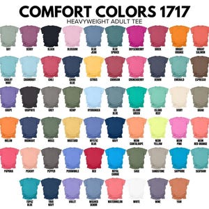 a collection of various adult t-shirt colors, ranging from pastel shades to bold, vibrant hues. The colors are organized in a grid format, with each row representing a different color and each column representing a different type of t-shirt. The text above the image reads "COMFORT COLORS 1717 HEAVYWEIGHT ADULT T-SHIRT".