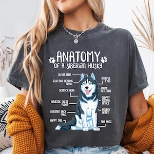 a person wearing a grey t-shirt with a graphic of a Siberian Husky and text that provides an anatomical diagram of the breed.
