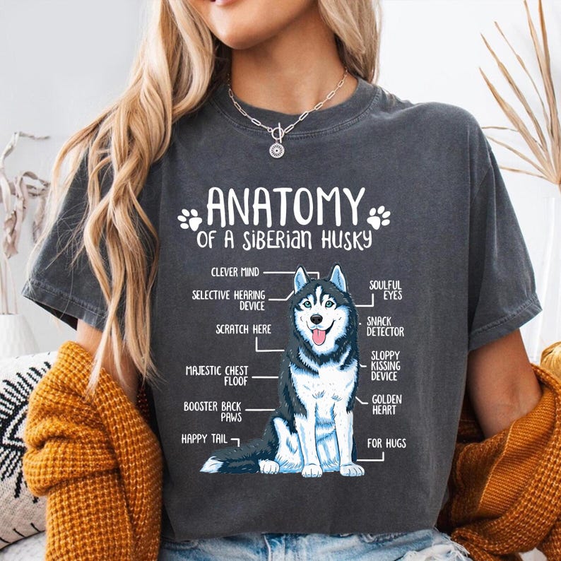 a person wearing a grey t-shirt with a graphic of a Siberian Husky and text that provides an anatomical diagram of the breed.
