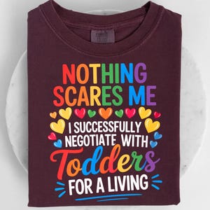a dark-colored t-shirt with a colorful graphic design and text printed on it.