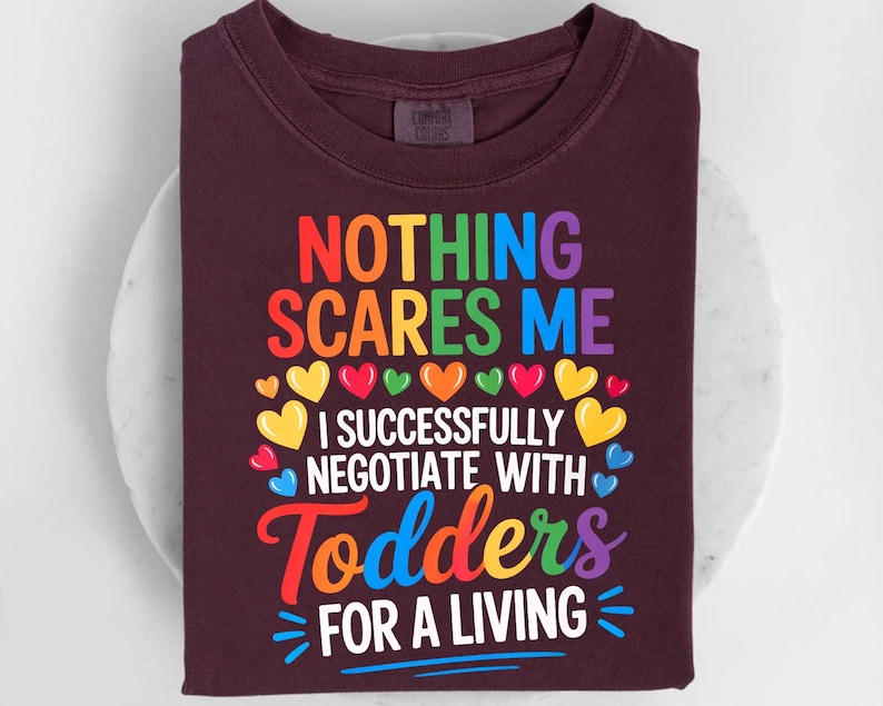 a dark-colored t-shirt with a colorful graphic design and text printed on it.