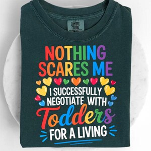 a dark green t-shirt with a colorful graphic design and text printed on it.