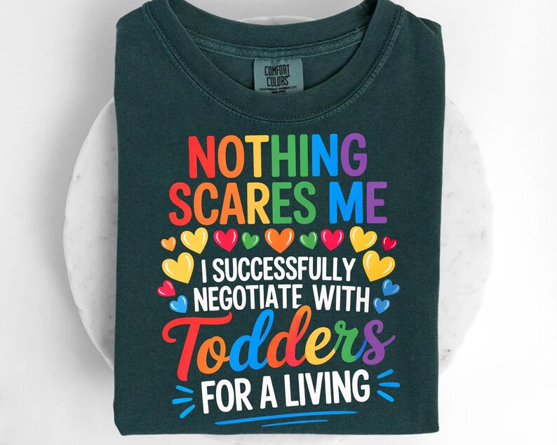 a dark green t-shirt with a colorful graphic design and text printed on it.
