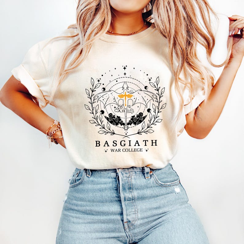 A woman wearing a white t-shirt with a graphic design and text, paired with blue jeans.
