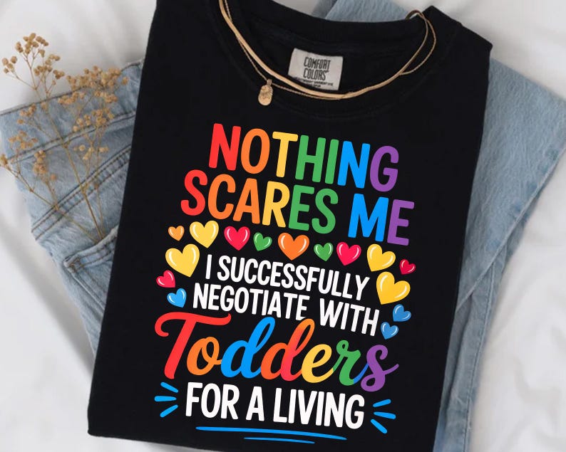 a black t-shirt with a colorful graphic design and text printed on it.