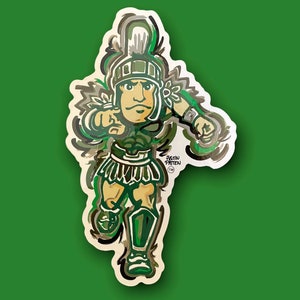 May include: A green, brown, and white cartoon illustration of a Spartan warrior wearing a helmet and holding a spear. The warrior is pointing with his left hand and has a determined expression on his face. The illustration is surrounded by a white border.