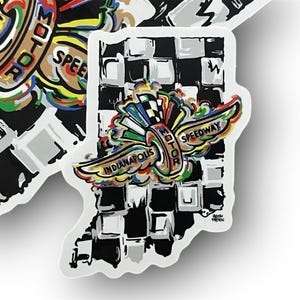 May include: A set of stickers featuring the Indianapolis Motor Speedway logo. The stickers are in the shape of the state of Indiana, with a black and white checkered background. The logo includes the words "Indianapolis Motor Speedway" and "Speedway" with colorful wings.