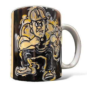 May include: A ceramic mug with a white handle and a black background. The mug features a cartoon illustration of a construction worker in yellow, black, and white. The worker is wearing a hard hat and holding tools.