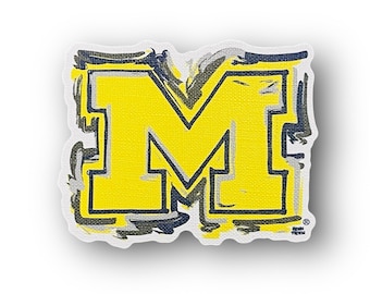May include: A yellow letter M with a black outline and gray brushstrokes around the edges. The letter is on a white background.