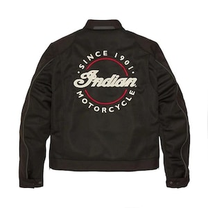 Pode incluir: Casaco de motociclista preto com o logotipo Indian Motorcycle nas costas. O logotipo está em um design circular com as palavras "SINCE 1901" e "MOTORCYCLE" em torno do nome da marca em vermelho e branco. O casaco tem um fecho de correr.