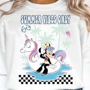 May include: White sweatshirt with a graphic featuring Minnie Mouse on a unicorn floatie, palm trees, and the text "SUMMER VIBES ONLY." The design includes sunglasses and an ice pop. The sweatshirt has a crew neck.