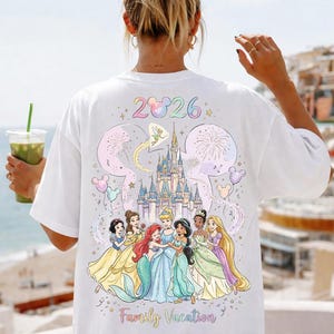 May include: A white ceramic mug with a black handle and the text "But First, Coffee" in a handwritten style. The mug is on a white surface. The mug is approximately 4 inches tall.