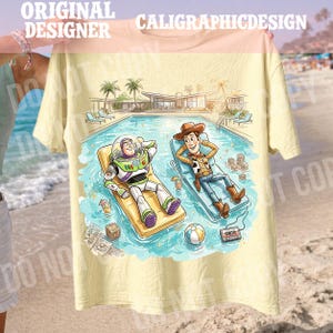 May include: Yellow t-shirt featuring a cartoon illustration of Buzz Lightyear and Woody relaxing in a pool. The design includes a pool, palm trees, and the text "CALIGRAPHICDESIGN" at the top. The shirt is held up by a person.