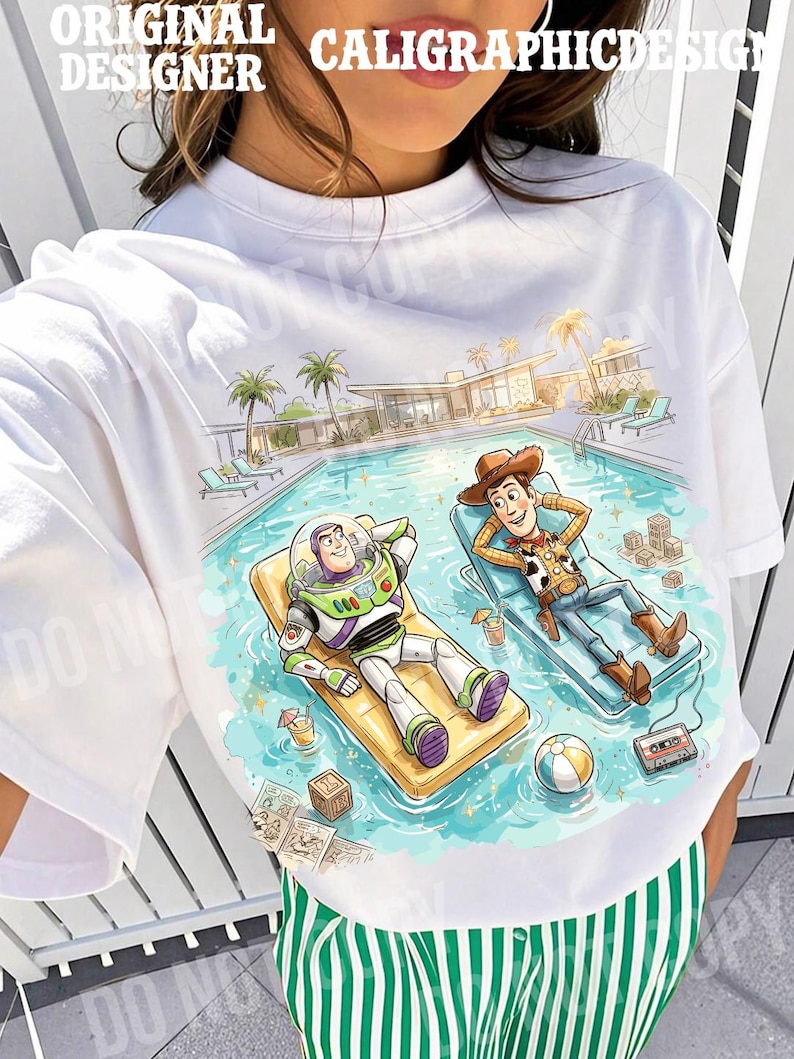 May include: White t-shirt featuring a colorful illustration of Buzz Lightyear and Woody relaxing by a pool. The design includes palm trees, a modern house, and the text "ORIGINAL DESIGNER CALIGRAPHICDESIGN".