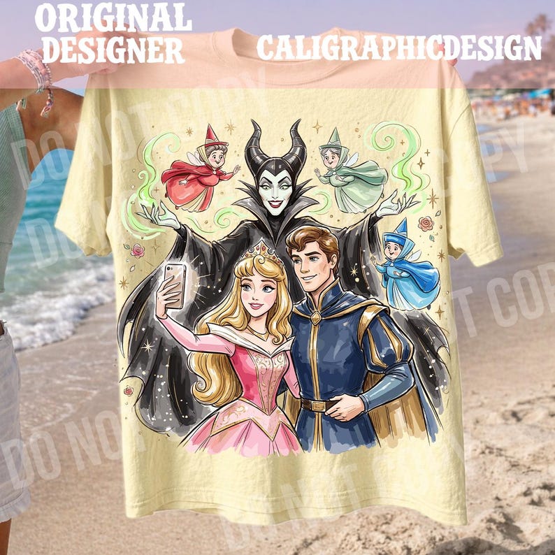 May include: A light yellow t-shirt with a colourful illustration of fairy tale characters. The design includes a princess, a prince, and a villain taking a selfie, with fairies and the text "ORIGINAL DESIGNER CALIGRAPHICDESIGN".