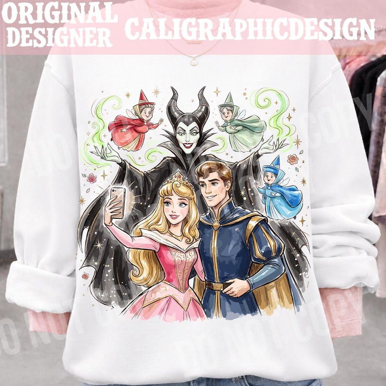 May include: White sweatshirt with a vibrant illustration of fairy tale characters. The design includes a princess, a prince, fairies, and a villain taking a selfie. The text "ORIGINAL DESIGNER CALIGRAPHICDESIGN" is at the top.