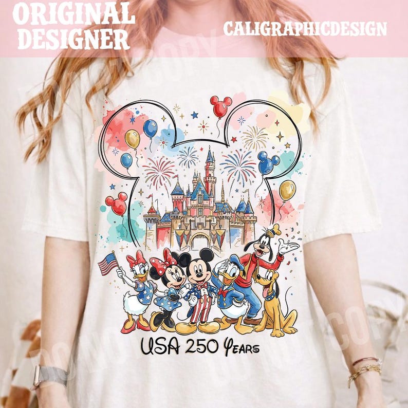 May include: White t-shirt featuring a colorful graphic of Disney characters, a castle, fireworks, and balloons. The text "USA 250 Years" is printed below the characters. The design includes Mickey Mouse, Minnie Mouse, Donald Duck, Daisy Duck, and Goofy.