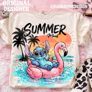 May include: Cream-colored t-shirt with a graphic featuring Stitch from Lilo & Stitch on a pink flamingo float, with the text "SUMMER Mood". The design includes a sunset, palm trees, and water splashes.