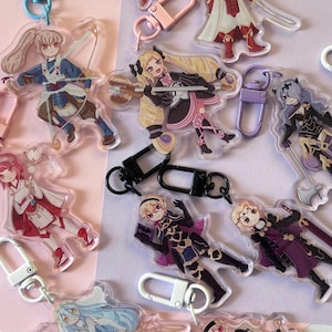 May include: A collection of acrylic character keychains featuring various anime-style figures. The keychains showcase detailed illustrations with vibrant colors and are attached to metal clasps. The figures are in dynamic poses, holding weapons or props, and are suitable for fans of anime.