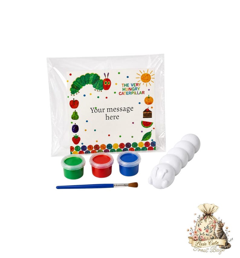 May include: A craft kit featuring a white caterpillar figure, three paint pots in green, red, and blue, and a paintbrush. The kit includes a clear bag with a colorful card featuring text from "The Very Hungry Caterpillar". The card reads "Your message here".